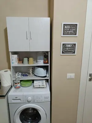 a kitchen with a washing machine in a room at NONNO PEPPE Suites 1, 2 & 3 in Terrasini