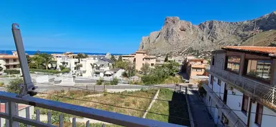 a view of a city with a mountain in the background at Casetta Sferracavallo in Palermo