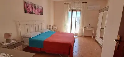 a bedroom with a bed with a colorful blanket at Casetta Sferracavallo in Palermo