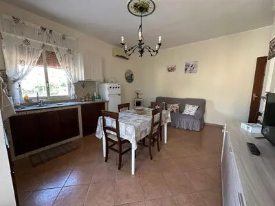 a kitchen and dining room with a table and chairs at Casetta Sferracavallo in Palermo
