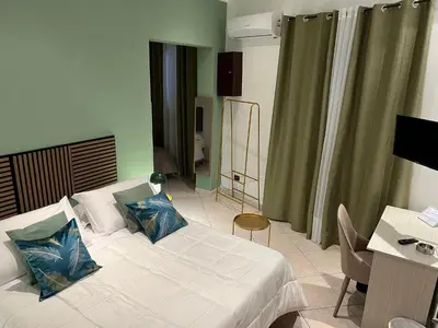 a bedroom with a bed with two pillows on it at la porta di Alba in Palermo