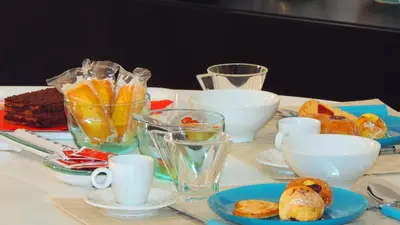 a table with bowls and plates of food on it at In Itinera in Palermo