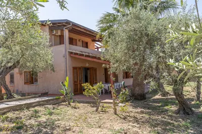 an exterior view of a house with trees at Casa Margherita Cefalù - Villa con accesso privato al mare in Cefalù