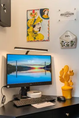 a desk with a computer monitor and a keyboard at Regina Suite in Palermo
