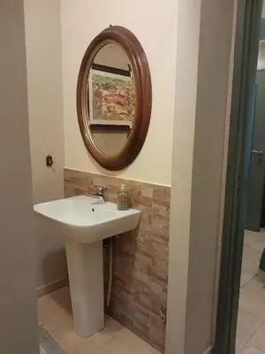 a bathroom with a sink and a mirror on the wall at Casa Castelli Holiday Apartment in Bagheria