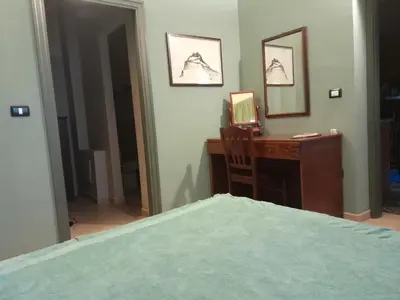 a bedroom with a desk with a computer and a bed at Casa Castelli Holiday Apartment in Bagheria