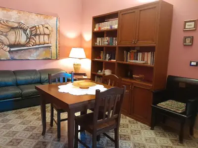 a living room with a table and a couch at Casa Castelli Holiday Apartment in Bagheria