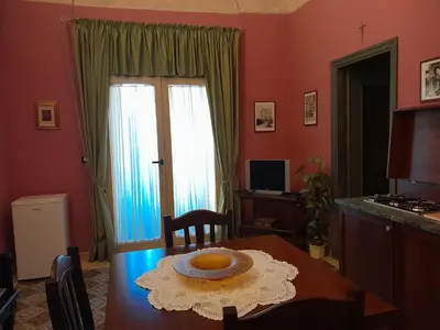a dining room with a table with a bowl on it at Casa Castelli Holiday Apartment in Bagheria