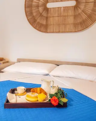 a tray of food on a table on a bed at Casa Marina in Palermo