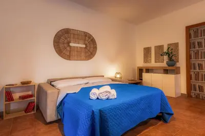 a bedroom with a bed with two towels on it at Casa Marina in Palermo