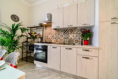 a kitchen with wooden cabinets and a stove at Le terrazze di Giulia in Palermo