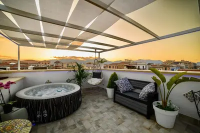 a hot tub on a balcony with a couch at Le terrazze di Giulia in Palermo