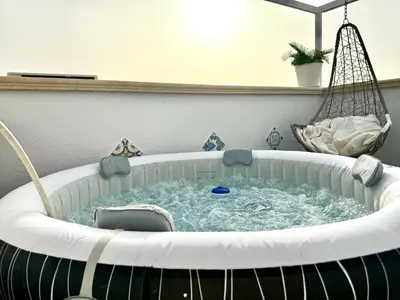 a hot tub in a room with a swing at Le terrazze di Giulia in Palermo