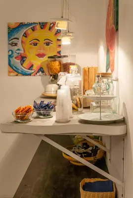 a shelf with bowls of food and a painting on the wall at C'era Una Volta in Palermo