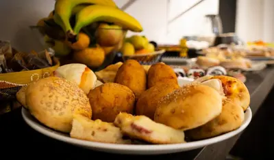 a plate of bread and fruit on a table at C'era Una Volta in Palermo