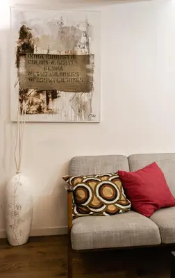 a living room with a couch and a painting on the wall at C'era Una Volta in Palermo