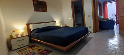 a bedroom with a bed with a blue comforter at Abba Palermo centro in Palermo