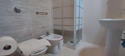 a white bathroom with a toilet and a sink at Abba Palermo centro in Palermo