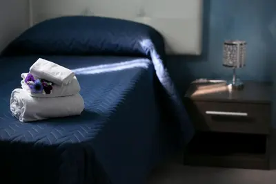 a pile of towels sitting on top of a bed at Rotte e Sentieri B&B in Castelluzzo