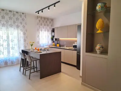 a kitchen with a table and chairs in a room at Casa Zolì - Luxury House - 210mq in Palermo