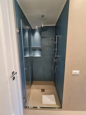 a bathroom with a shower with a glass door at Casa Zolì - Luxury House - 210mq in Palermo