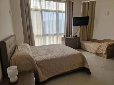 a bedroom with two beds and a window at Sara House Palermo in Palermo