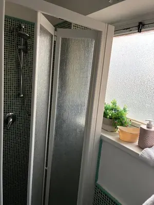 a shower with a glass door in a bathroom at Sara House Palermo in Palermo