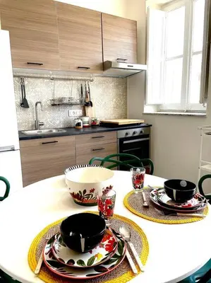a kitchen with a table with plates and bowls on it at Monkey house Appartamento in centro storico in Palermo