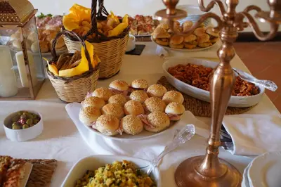 a table with plates of food and baskets of food at Villa Lampedusa in Palermo