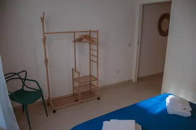 a room with a ladder and a bed and a chair at Ideisini's apartment in Palermo