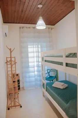 a bedroom with a bunk bed and a ladder at Ideisini's apartment in Palermo