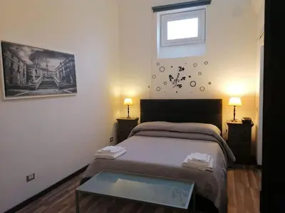 a bedroom with a bed and a glass table at Stella D'Oriente in Palermo