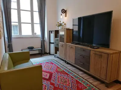 a living room with a large flat screen tv at Stella D'Oriente in Palermo