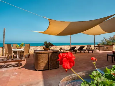 a patio with a table and chairs and the ocean at Apartment Sole by Interhome in Trappeto