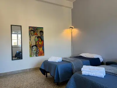 a room with two beds and a mirror at Ekry Apartment in Palermo