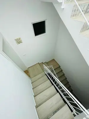 a spiral staircase with a television in a room at Amalcamo Apartments in Alcamo