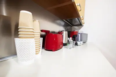 a kitchen with a counter with plates and appliances at Ai Bottonai Casa 23 in Palermo