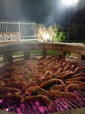 a bunch of sausages cooking on a grill at Casa Lachesi in Caccamo