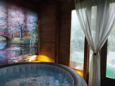 a bath tub in a room with a large window at Casa Lachesi in Caccamo