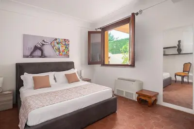 a bedroom with a large bed and a window at Villa lady olimpia in Palermo