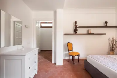 a bedroom with a bed and a desk and a chair at Villa lady olimpia in Palermo