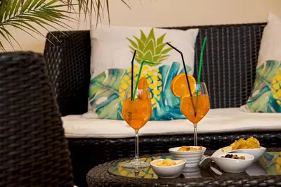 two glasses of orange juice sitting on a table at Ayres Del Mar in San Vito lo Capo