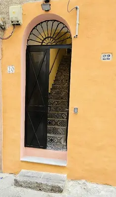 a black door with a stairs leading to a building at Vintage Room Palermo in Palermo