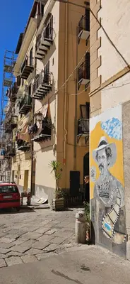 a mural of a man with a hat on the side of a building at Vintage Room Palermo in Palermo