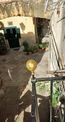 a gold object on a railing in front of a building at Vintage Room Palermo in Palermo