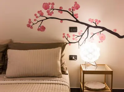 a branch of a tree with pink flowers on a wall at Villa Salvo in Balestrate