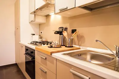 a kitchen with a sink and a stove top oven at Villa Salvo in Balestrate