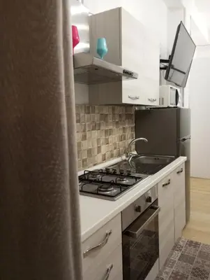 a kitchen with a stove and a refrigerator at Casa Chiaretta in Palermo