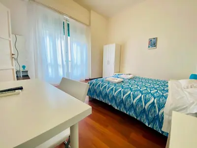 a small room with a bed and a table and a desk at Castelnuovo Rooms #Politeama in Palermo