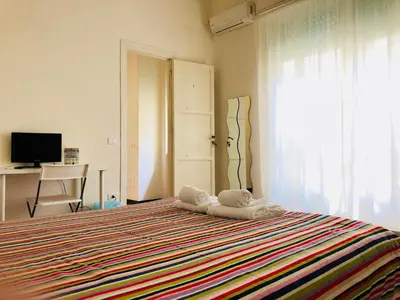 a bedroom with a bed with towels on it at Castelnuovo Rooms #Politeama in Palermo